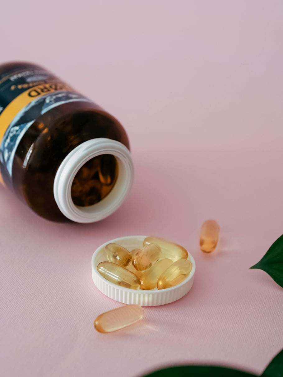 cod-liver-oil-vial-pills-capsules-healthcare-pink-backdrop-bottle-vitamin-d-omega-3-supplements.jpg